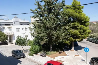 an overhead view of a street with trees and cars at The Pines apartment in Palaiá Fókaia