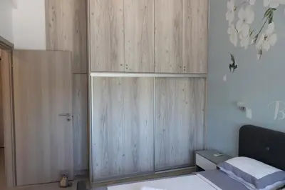 a bedroom with a large wooden cabinet in the corner at The Pines apartment in Palaiá Fókaia