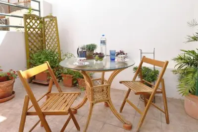 a glass table and two chairs and a table and chairs at Inviting Flat near Acropolis in Athens