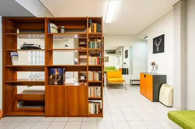 a room with a book shelf filled with books at Inviting Flat near Acropolis in Athens