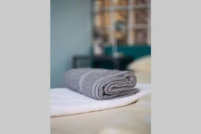 a stack of towels sitting on top of a table at Inviting Flat near Acropolis in Athens