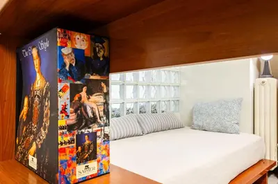 a bedroom with a bed with posters on the wall at Inviting Flat near Acropolis in Athens