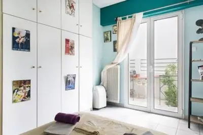 a living room with a bed and a window at Inviting Flat near Acropolis in Athens