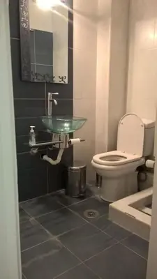 a bathroom with a toilet and a glass sink at Μοντέρνος χώρος στο κέντρο της πόλης in Athens