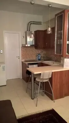 a kitchen with a table and a counter top at Μοντέρνος χώρος στο κέντρο της πόλης in Athens