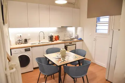 a kitchen with a table and chairs and a sink at Ηλιόλουστο in Athens