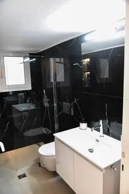 a bathroom with a white sink and a toilet at Ηλιόλουστο in Athens