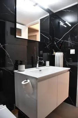 a bathroom with a white sink and a mirror at Ηλιόλουστο in Athens