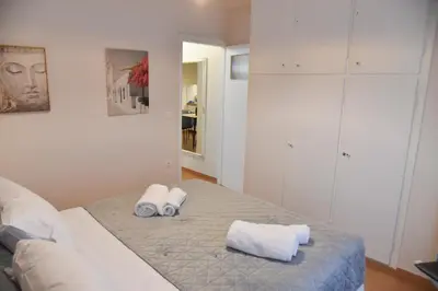 a bedroom with a bed with two towels on it at Ηλιόλουστο in Athens