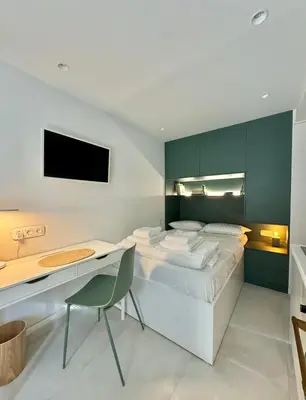 a bedroom with a bed and a desk with a computer at Microhome in Philopappos Hill in Athens