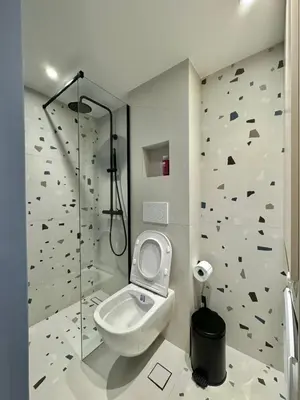 a bathroom with a toilet and a shower at Microhome in Philopappos Hill in Athens