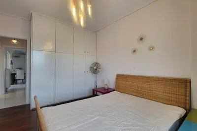 a bedroom with a large bed in a room at Spacious top flat with panoramic rooftop in Athens