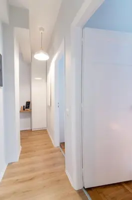 an empty hallway with white walls and wooden floors at Ella's Cozy escape with balcony! in Athens