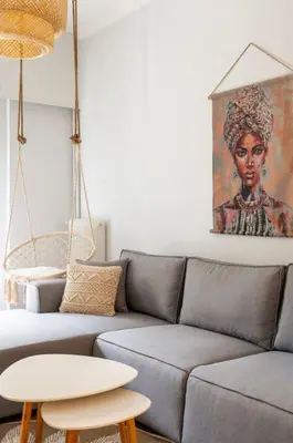 a living room with a couch and a table at Ella's Cozy escape with balcony! in Athens