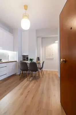 a kitchen and dining room with a table and chairs at Ella's Cozy escape with balcony! in Athens
