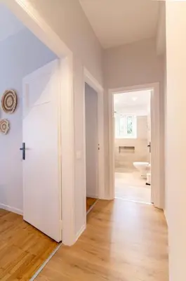 an empty room with a white door and a bathroom at Ella's Cozy escape with balcony! in Athens