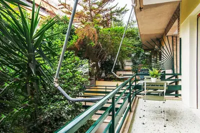a balcony of a house with a table and chairs at Ella's Cozy escape with balcony! in Athens