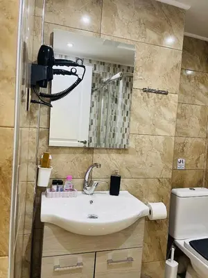 a bathroom with a sink and a mirror at Narek luxury Apartment's in Athens