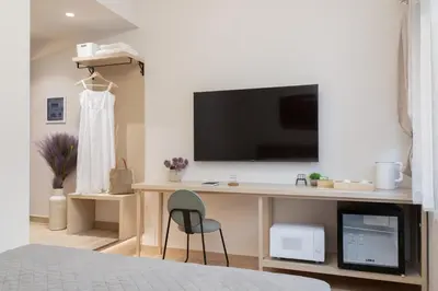 a bedroom with a desk with a television and a chair at M18 Studios Monastiraki Gems in Athens