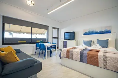 a bedroom with a bed and a table and a chair at Stylish studio for 2 in Abelokipi by MPS in Athens