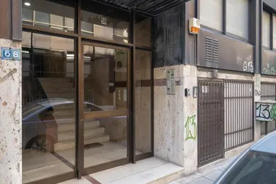 a building with glass doors with a car in it at Stylish studio for 2 in Abelokipi by MPS in Athens