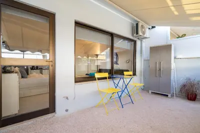 a room with a table and chairs and a bedroom at Stylish studio for 2 in Abelokipi by MPS in Athens