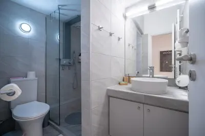 a bathroom with a toilet and a sink and a shower at Stylish studio for 2 in Abelokipi by MPS in Athens