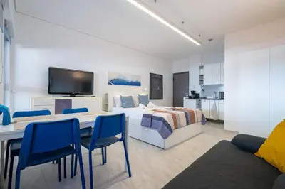 a bedroom with a bed and a table and chairs at Stylish studio for 2 in Abelokipi by MPS in Athens
