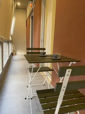 a room with two tables and chairs in a building at Byrons Cozy Place in Athens