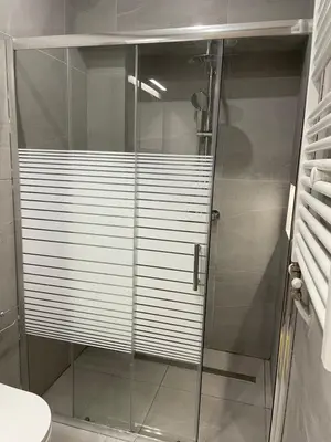 a shower with a glass door in a bathroom at Byrons Cozy Place in Athens