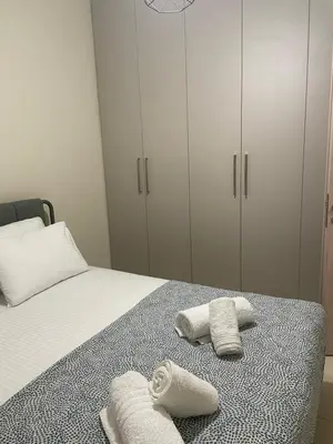 a bedroom with a bed with towels on it at Byrons Cozy Place in Athens