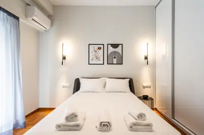 a bedroom with a bed with towels on it at LIV - Peaceful Pagrati Getaway in Athens