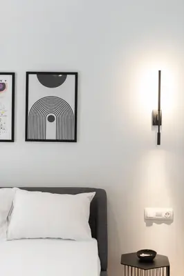 a bedroom with a bed and two pictures on the wall at LIV - Peaceful Pagrati Getaway in Athens