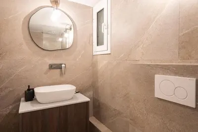 a bathroom with a sink and a mirror at LIV - Peaceful Pagrati Getaway in Athens
