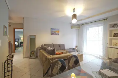 a living room with a couch and a table at Seaside Spacious 2 BR, 2BA, Sea view Apt in Piraeus