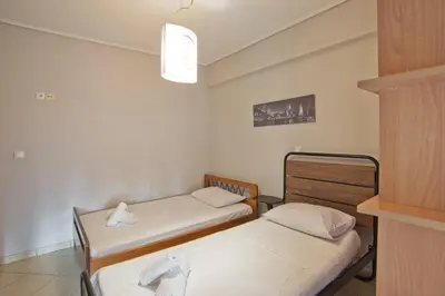 a room with two beds in a room at Seaside Spacious 2 BR, 2BA, Sea view Apt in Piraeus