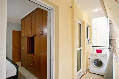 a laundry room with a washer and a washing machine at Seaside Spacious 2 BR, 2BA, Sea view Apt in Piraeus