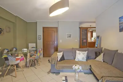 a living room with a couch and a table at Seaside Spacious 2 BR, 2BA, Sea view Apt in Piraeus