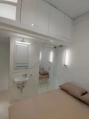 a white bathroom with a sink and a mirror at AMG Stylish Small Apartment in Pagkrati Close to Metro in Athens