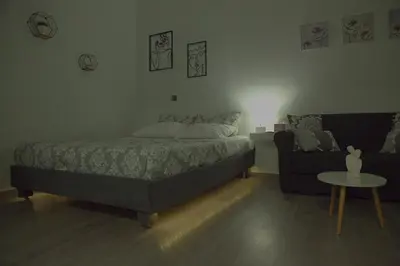 a bedroom with a bed and a couch and a table at Athens Dream in Athens