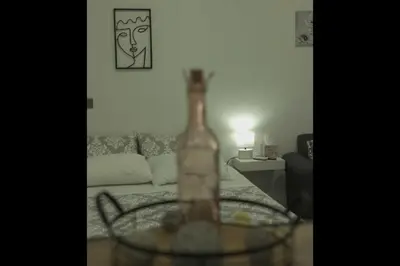 a bottle sitting on a table in a living room at Athens Dream in Athens