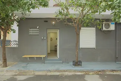 a house with a bench sitting outside of it at Athens Dream in Athens