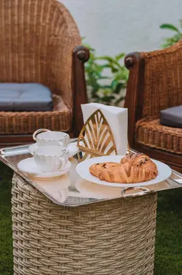 a table with a tray with a plate of bread on it at YourHostess in Athens
