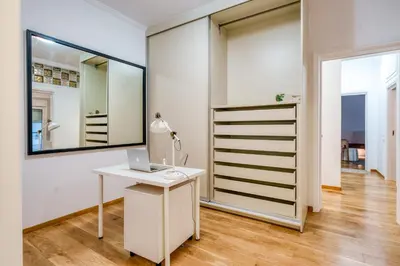 a white room with a desk and a mirror at YourHostess in Athens