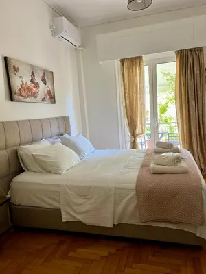 a bedroom with a large bed and a window at TOMS apartment Acropolis district in Athens