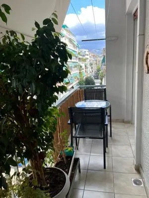 a balcony with a table and a potted plant at TOMS apartment Acropolis district in Athens