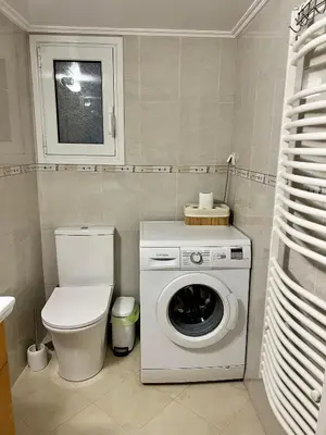 a bathroom with a washing machine and a toilet at TOMS apartment Acropolis district in Athens