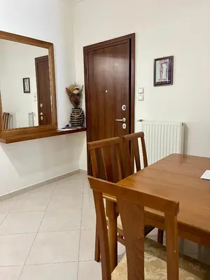 a dining room with a wooden table and a mirror at TOMS apartment Acropolis district in Athens