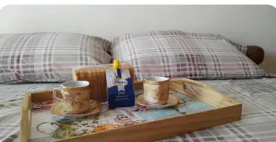 a tray with two coffee cups on a bed at Vintage house by the sea in althea in Aghia Marina