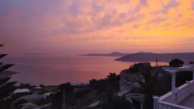 a view of the ocean at sunset at Vintage house by the sea in althea in Aghia Marina